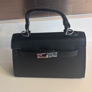 Black Leather Handbag with Silver Accents. 
Fits a 12 pro max phone & bigger ❤️